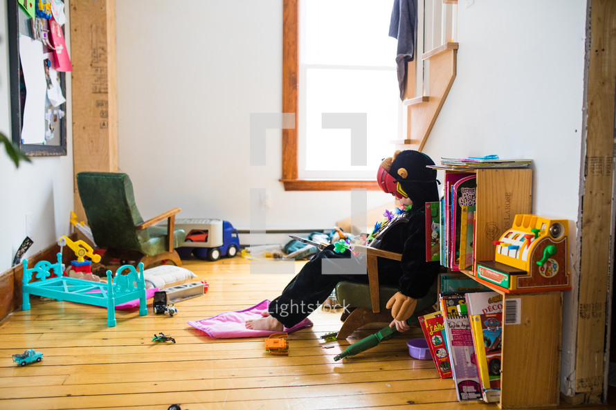 child in a messy playroom