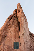 red rock peak with a plaque 