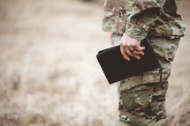 soldier holding a Bible 
