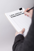 A man signing up to be in a life group 