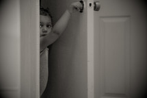 a toddler opening a door 