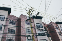 power lines on power poles and apartments 