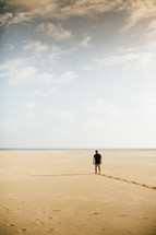 a man walking on a beach 
