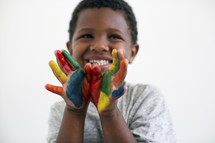A little boy with painted hands 