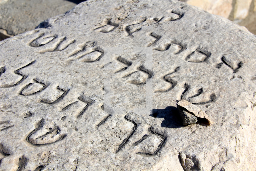 Hebrew letters carved into a grave stone.