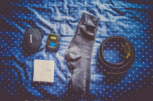 socks, handkerchief, belt, sound equipment on a bed
