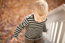toddler boy walking up stairs