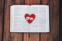 red heart on the pages of a Bible 