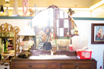 Woman taking a photograph in an antique shopl