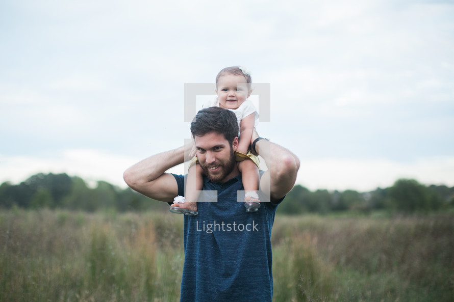 toddler girl on father's shoulders 