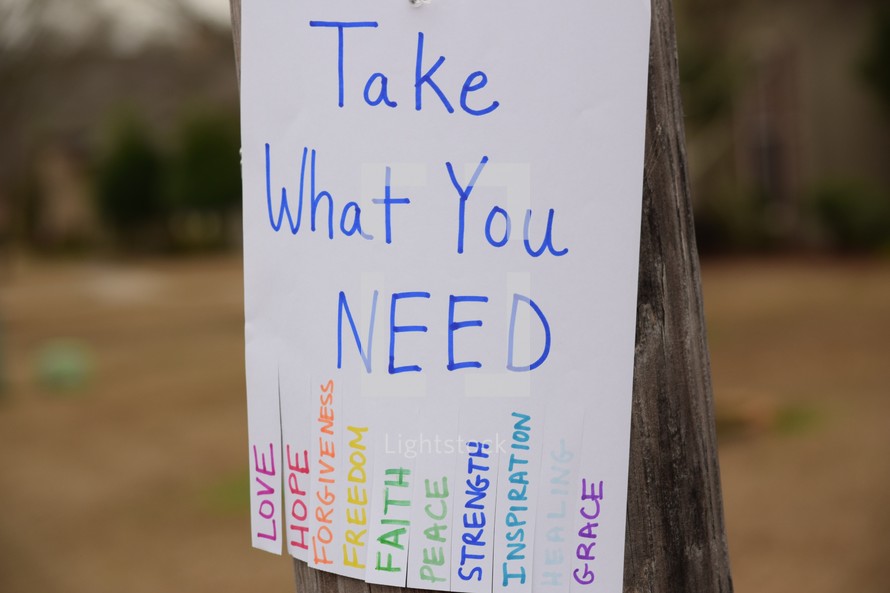 Take What you need flyer hanging on a telephone pole 