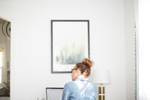 woman sitting at a home office desk 