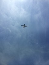 looking up at a plane in flight 