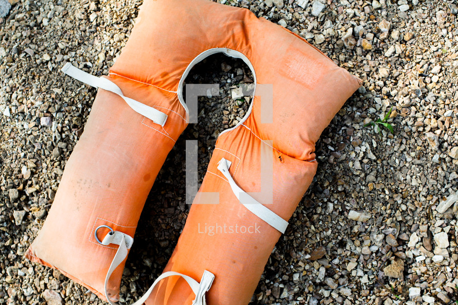 orange lifejacket on the ground 