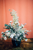 a flower arrangement on a wood table 
