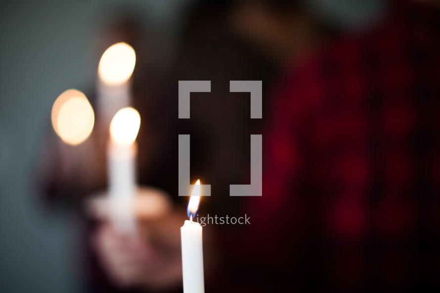 People holding candles for a candlelight service