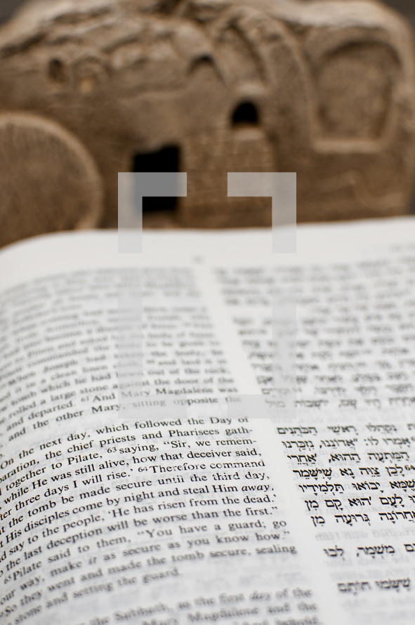 New Testament in Hebrew and English with Tomb in the Background