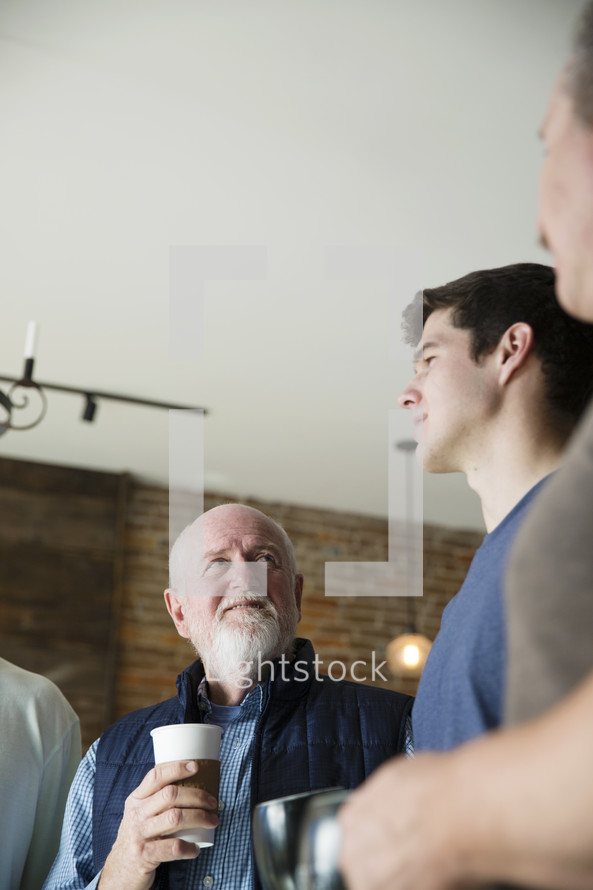 men's group with coffee mugs 