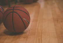 basketballs on a wood court 