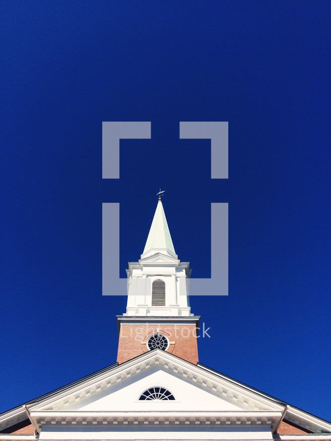 church steeple against a cobalt blue sky 