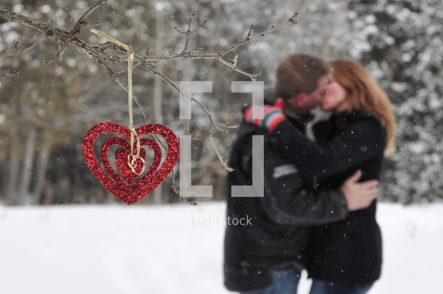 a couple kissing in snow 