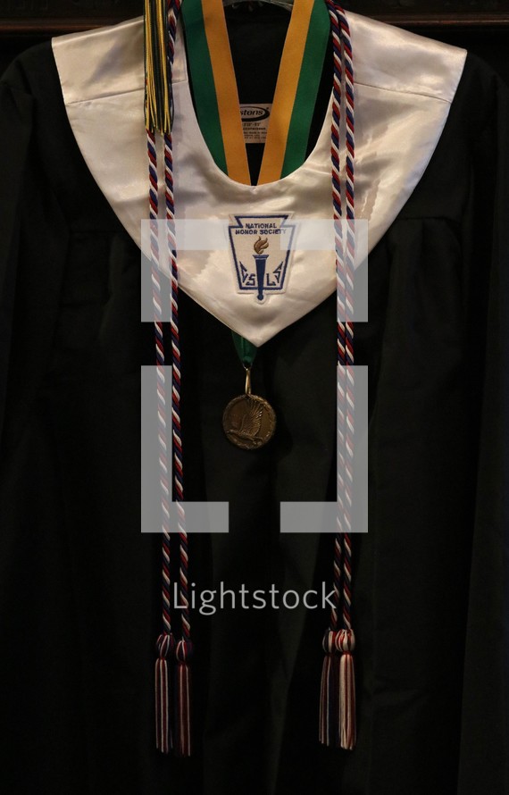 cap and gown with medals and ribbons