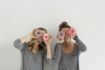 women holding donuts and acting silly 