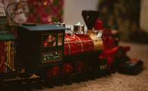 Christmas toy train around a Christmas tree 