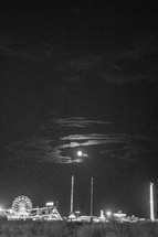 full moon over an amusement park 