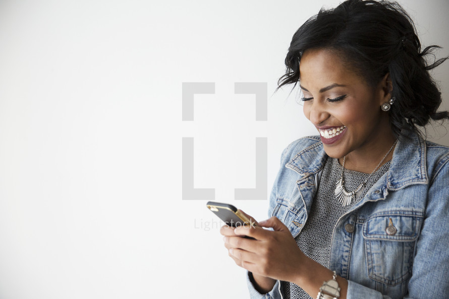 An African American woman texting on a cellphone 