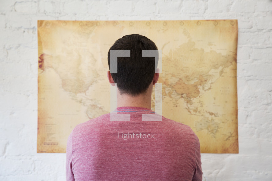a man looking at a world map 