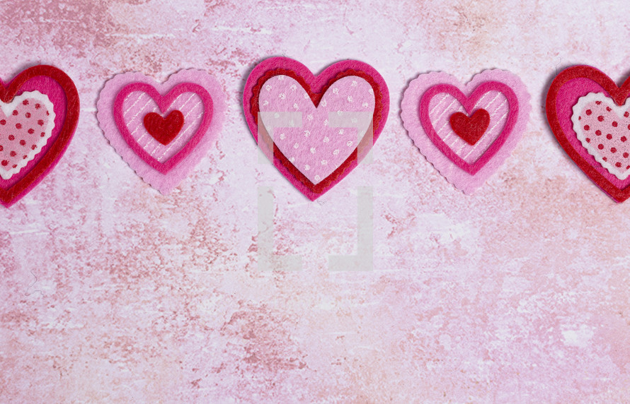 Simple Background with Felt Love Hearts on a Pink Background