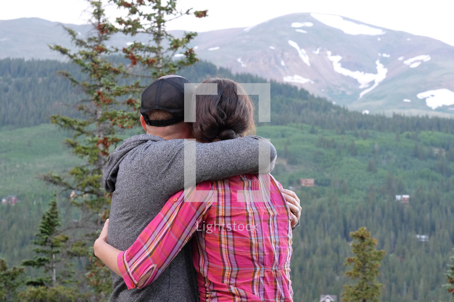 couple hugging and a mountain view 