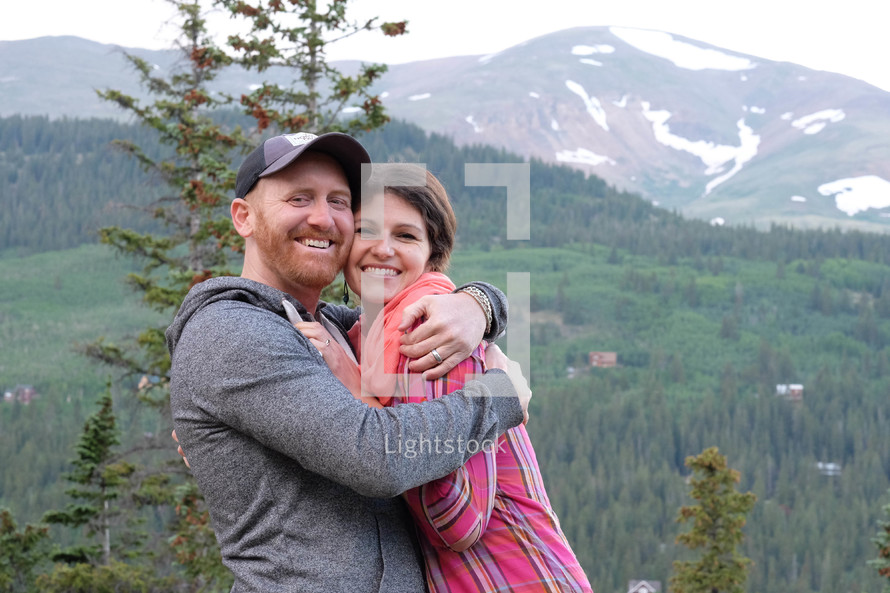 couple hugging and a mountain view 