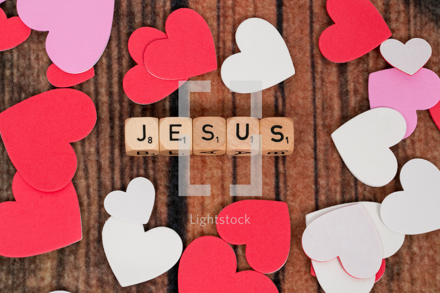 paper hearts and word Jesus on scrabble pieces 