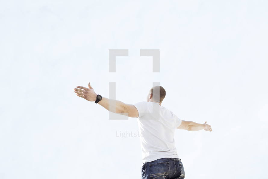 a man standing with arms outstretched 