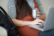 a woman with a laptop and coffee cup 