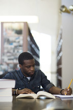 a man studying in a library 