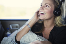 woman riding in a car listening to headphones 