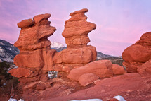 The Siamese Twins rock formation at Garden of the Gods. Pikes Peak can be seen  between the formations