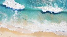 Top down view of beach in the summer with waves. 