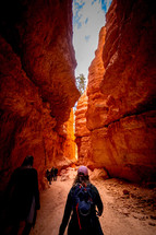 people exploring a red rock canyon 