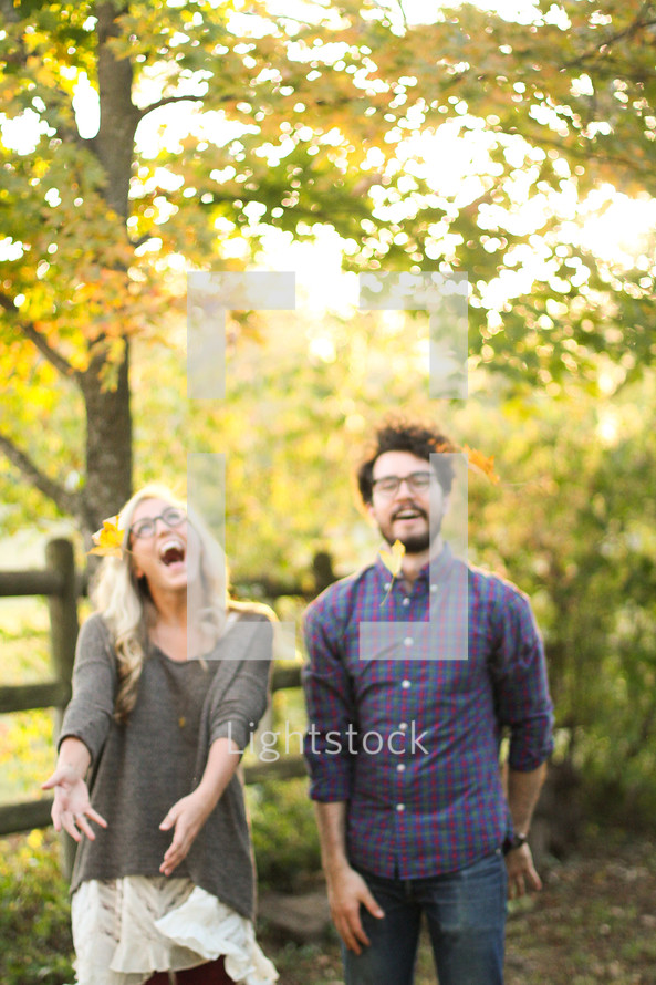 couple standing together laughing outdoors 