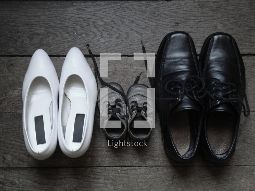 family - shoes, 
familiy, shoes, parents, child, size, different, baby, father, mother, home, floor, wood, wooden flooring, black, white, brown, pumps, toddler