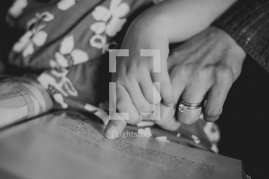 mother and daughter reading a Bible together