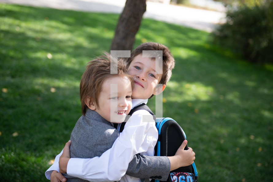brothers hugging outdoors 