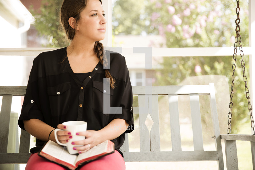 woman on a porch swing with a Bible and coffee 