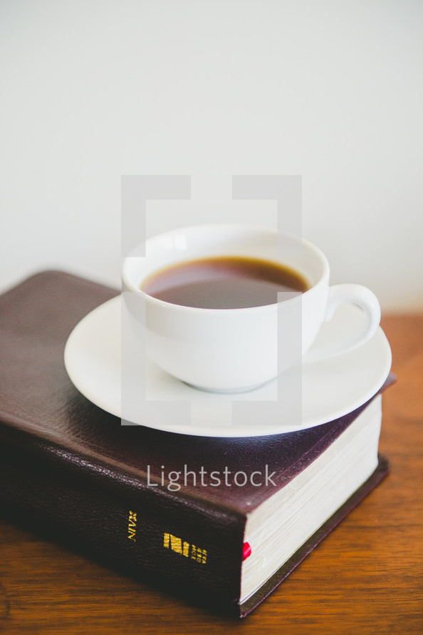 coffee cup on a Bible 