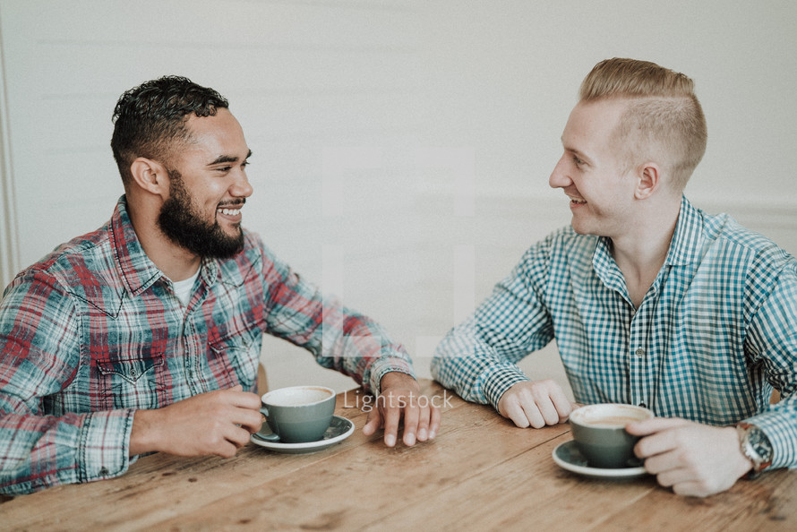 two men talking over coffee