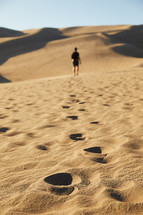 a man exploring sand dunes 